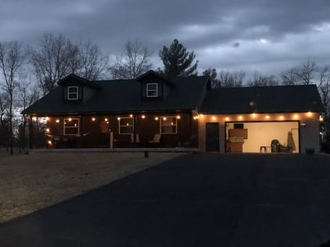 Relax on the large covered porch with many cushioned chairs and a double hammock