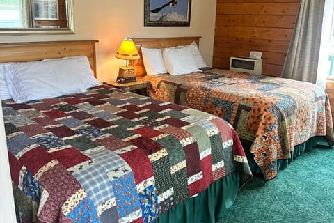 The room features a queen bed and a full bed. 