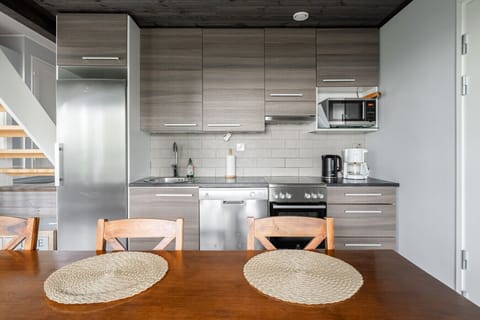 The modern kitchen is fully equipped with everything you need, including a dishwasher, oven, stove, fridge, and all essential cookware and utensils.