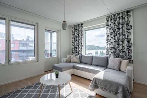 Relax after a day of exploring on the comfortable sectional sofa in this bright, modern living room, complete with a view of the lake and marina.