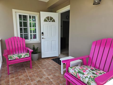 Breezy porch with comfortable armchairs overlooking a tropical garden