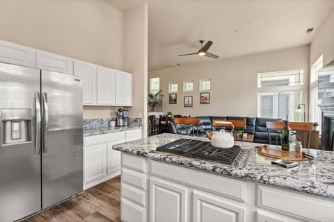 Modern kitchen with granite countertops, stainless steel appliances, and open flow into the living space—perfect for cooking, entertaining, and staying connected while you unwind.