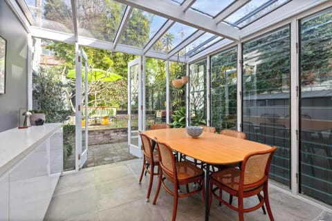 Dine under the light in this glasshouse-style room that opens to the backyard—sunny breakfasts or candlelit dinners await.
