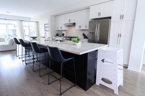 This sleek, modern kitchen is perfect for entertaining, with its large island, stainless steel appliances, and ample counter space. You'll love cooking and gathering in this stylish space.