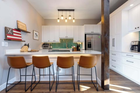 Updated kitchen connected to main living room area and dining area. Bar stools for 4 and table seating for 6