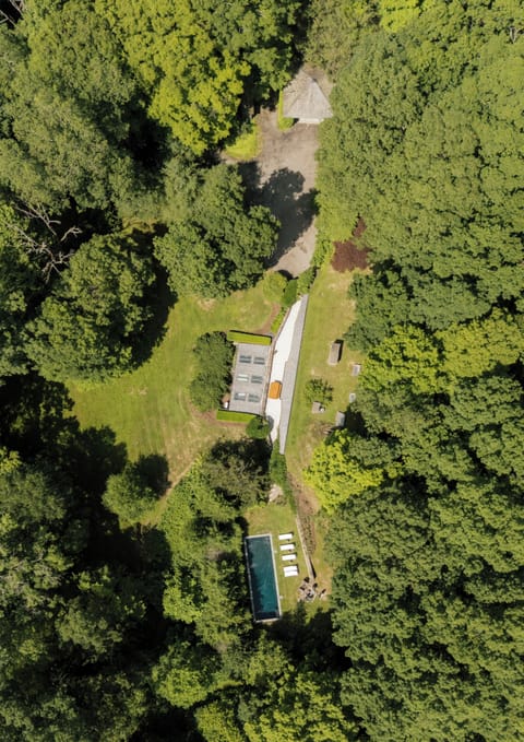 Aerial view - main driveway, berm home, pool area, front yard