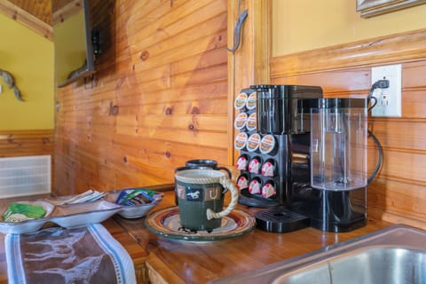 Coffee bar with Keurig coffee pot with coffee pods, creamer and sweeteners.