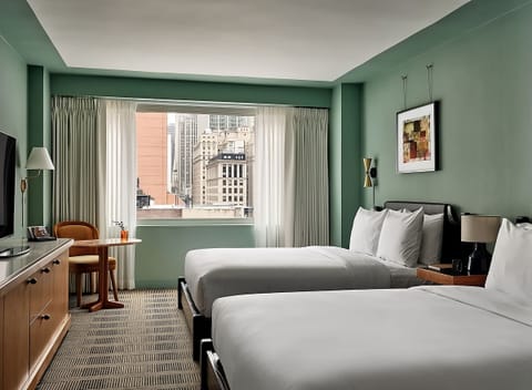 Unwind in airy comfort with skyline views and plush beds.