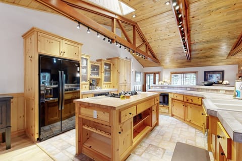 Fully equipped cabin kitchen with ample cabinetry, stove, fridge, microwave, and coffee maker—perfect for cooking meals, morning coffee, and feeling right at home on your stay.