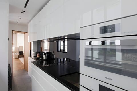 Kitchen - Black granite bench, steam oven above the standard oven
