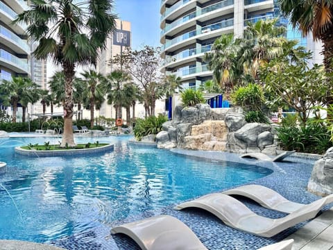Pool Oasis: Dive into luxury with lush palms, rock features, and crystal-clear waters!
