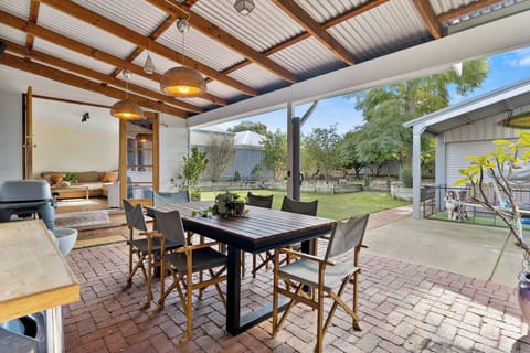 Enjoy alfresco meals in the spacious outdoor dining area. The dog in the photo is for photography purposes only — please disregard.