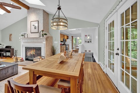 Elegant dining meets glowing hearth and open kitchen.
