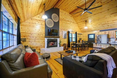 Cozy open living area with fireplace, smart TV, and queen sleeper