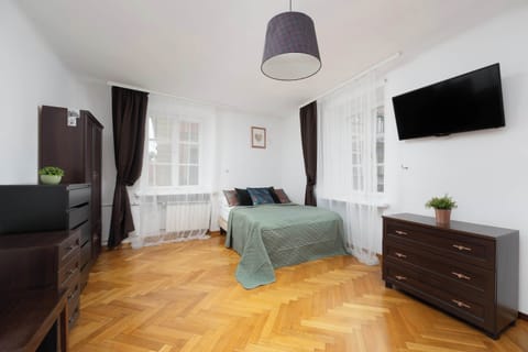 A stylish and well-lit bedroom featuring a plush double bed, sophisticated décor, and blackout curtains for restful sleep.