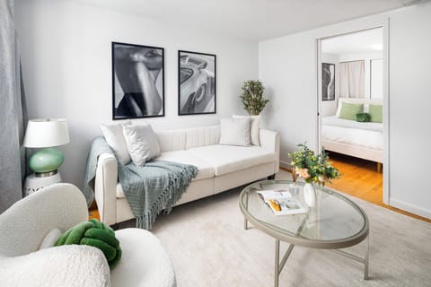 Chic living room with cozy seating, wall art, and soft natural light
