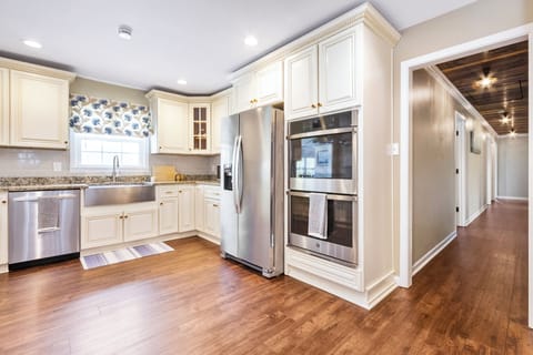 Open kitchen w/ double oven.  Hallway leads to bedrooms, bathrooms and stairs