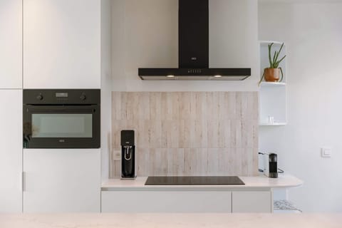 Stylish kitchen with modern appliances, induction cooktop, and sleek black accents