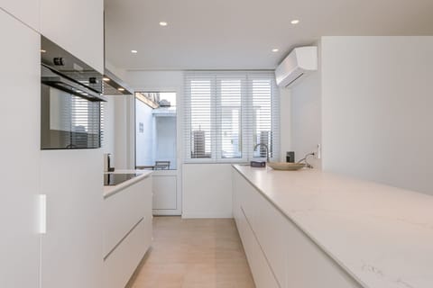 Bright, modern kitchen with sleek white finishes and built-in appliances