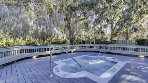 Unwind in the secluded hot tub surrounded by tranquil trees.