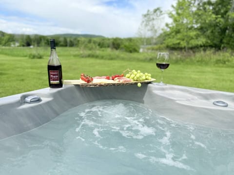 Unwind in the bubbling hot tub with scenic views and a delightful wine platter!