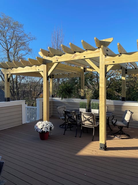 Rooftop deck with Pergola and table along with casual seating with Outdoor TV. 