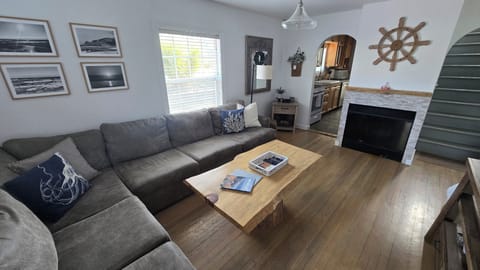 Living room has Smart TV and record player.