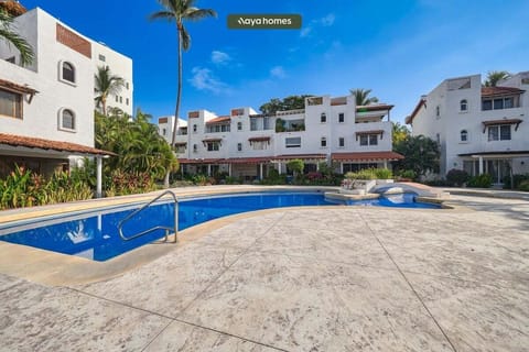 Relax by the sparkling community pool surrounded by tropical landscaping, sun loungers, and a peaceful atmosphere perfect for unwinding under the Caribbean sun.