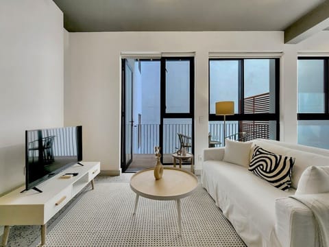 Open plan living room leading out to the balcony area