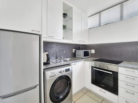 Full kitchen with modern finishes and sleek feel