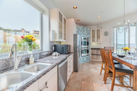 The kitchen features double ovens, microwave and views!