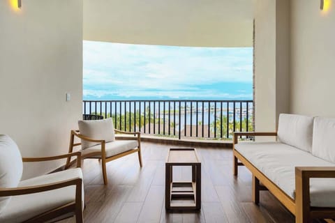 Relax on your private terrace overlooking the pool, complete with plush lounge chairs for soaking up the sun
