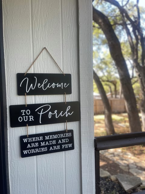 A welcoming sign sets the tone on the porch