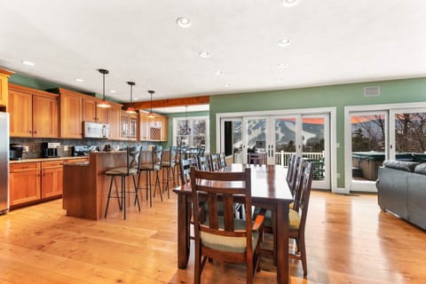 Large 10-person dining table and the open-concept kitchen with seating for 4 more at the bar and another 4 at the breakfast nook