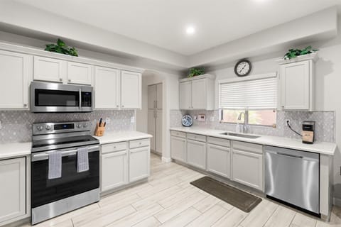 Whip up vacation magic! This bright, modern kitchen is fully stocked and ready for everything from pancake breakfasts to sunset dinners.