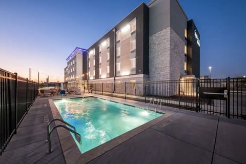 Unwind at dusk with a glowing pool and calm ambiance