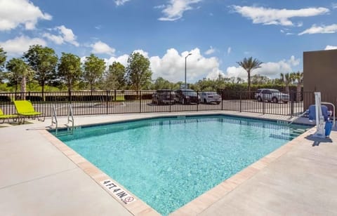 Dive into sunlit afternoons by the sparkling outdoor pool.