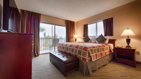 Unwind in a sunlit king bedroom with private balcony views.
