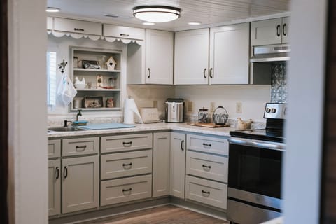 Full kitchen with complete cooking utensils and retro refrigerator and mocrowave