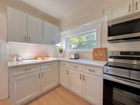 fully stocked kitchen plenty of cookware & dining utensils 