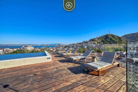 Unwind on our gorgeous wooden rooftop deck. Take a refreshing dip in the plunge pool or relax on the sun loungers while enjoying sweeping views of the city and bay.