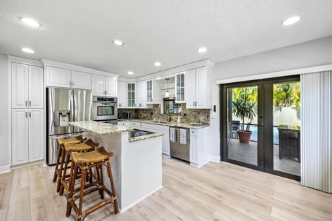 Contemporary lounge with designer coffee table, open kitchen, and fresh style