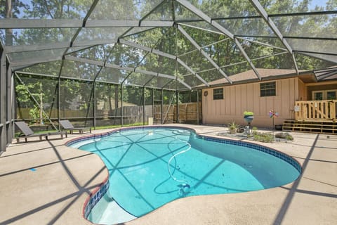 Large screen area with lounge chairs and pool