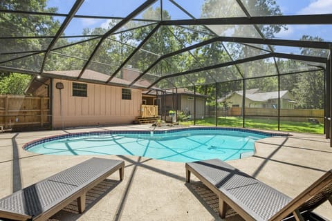 Large screen area with lounge chairs and pool