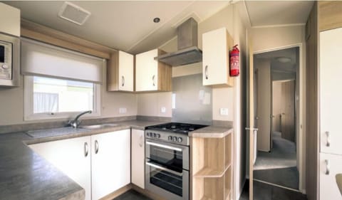 This is the kitchen it has a gas cooker/gas hob and a microwave and also an air fryer and toaster/kettle.