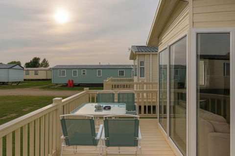 Terrace with a table and chairs to sit on has 4 seats and a umbrella to put over the table also has lovely lights at night when sitting outside.