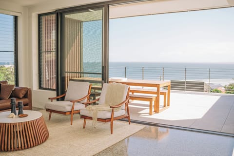 Indoor spaces flow onto balconies offering uninterrupted views of the coastline.