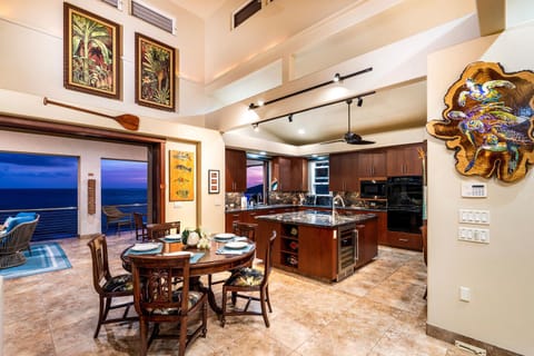 Five-burner cooktop, granite island, and a handy pass-through window keep the conversation flowing from stove to lanai.