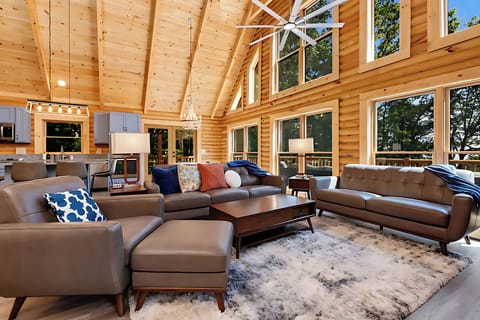 Living room with vaulted ceiling, open to kitchen and dining