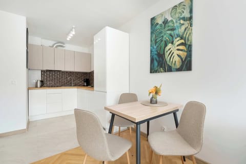 A functional kitchen and dining area with table and chairs creates a suitable space for preparing home-cooked meals.
